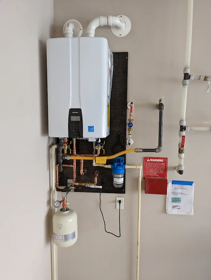Professional plumber installing copper piping in a Whiting home